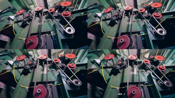金属齿轮在纺织厂的机器上工作。