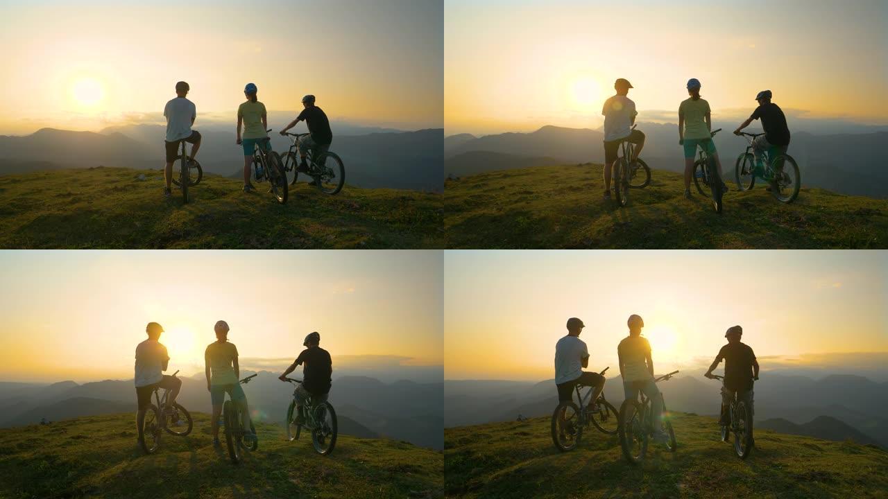 镜头耀斑: 无法识别的运动型游客在自行车上休息并观察日出