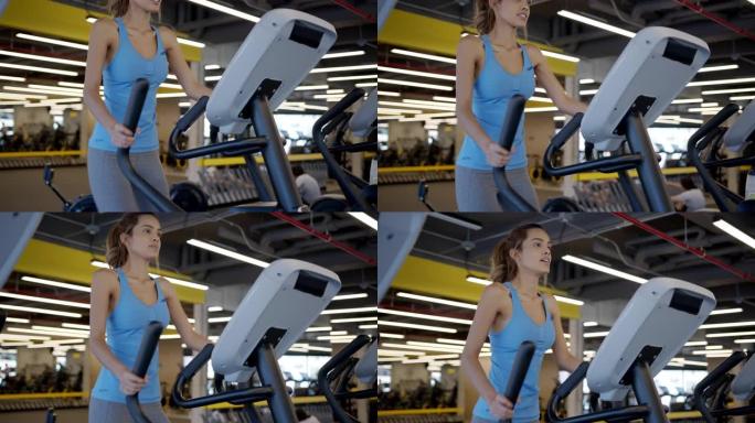年轻的瘦女人在健身房的椭圆机上锻炼
