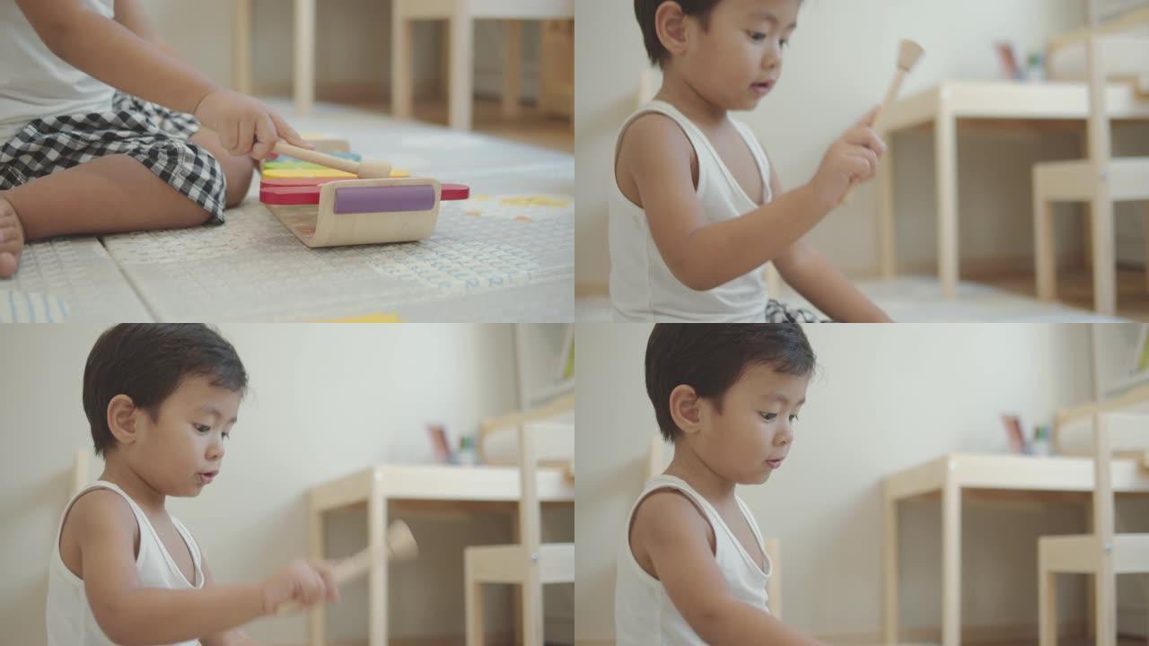 亚洲男婴在家玩木琴