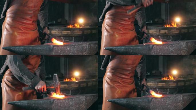 铁匠铺工人正在用锤子敲打加热的金属