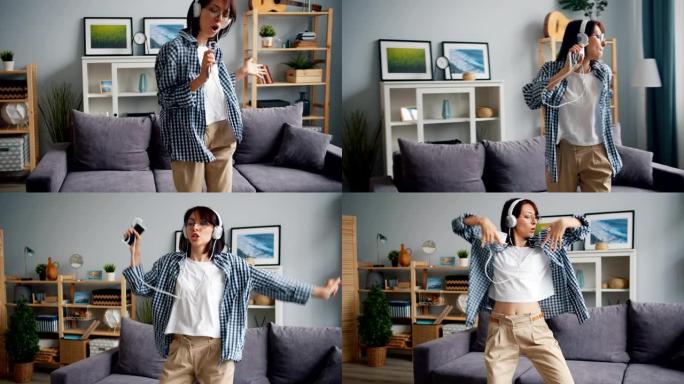 有趣的年轻女士在智能手机上唱歌听音乐跳舞玩得开心