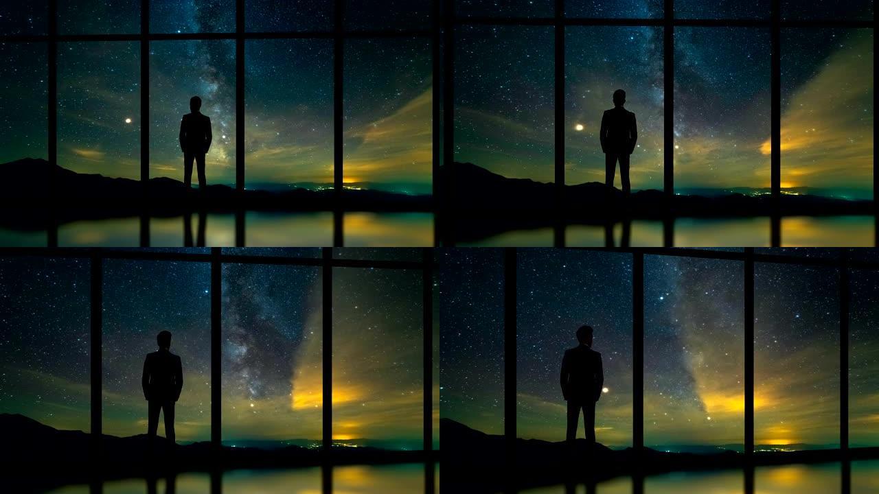 站在星空背景上的全景窗口附近的男性。时间流逝