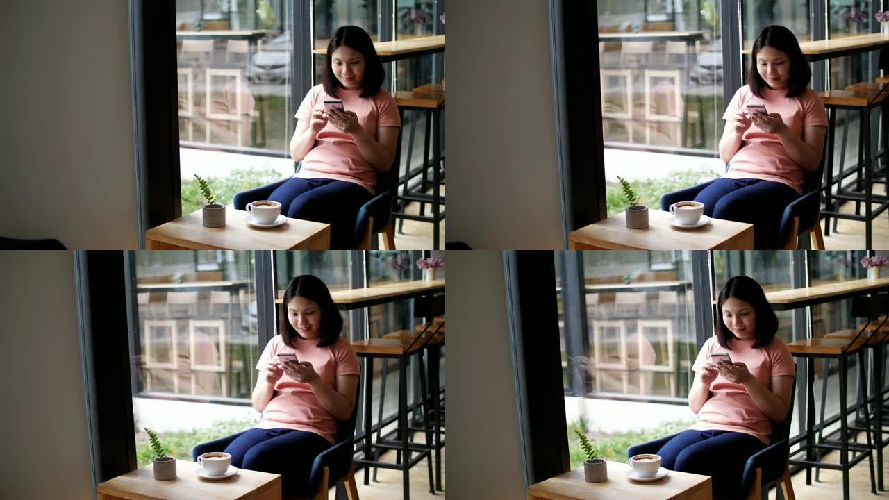 女人使用智能手机在咖啡厅喝咖啡，慢动作
