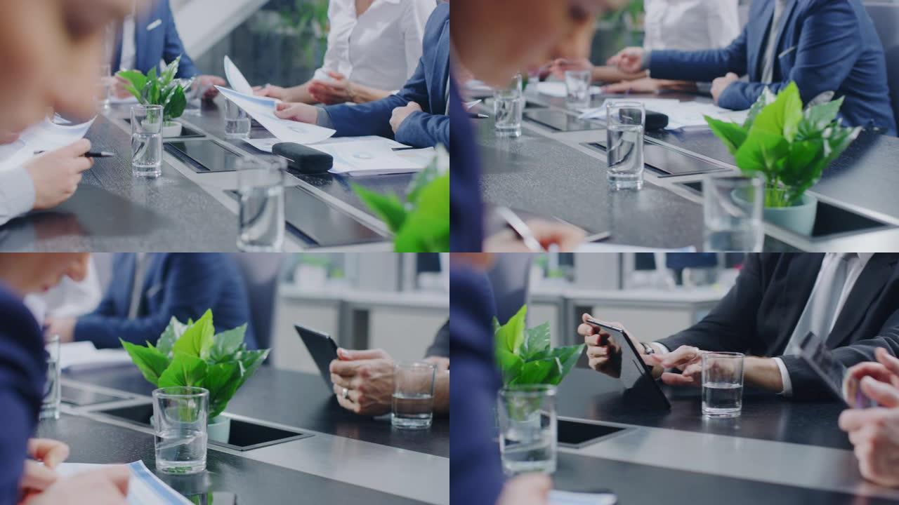 在公司会议室的特写镜头中，商人，使用智能手机和数字平板电脑签署合同，比划着手势。坐在会议桌旁的人