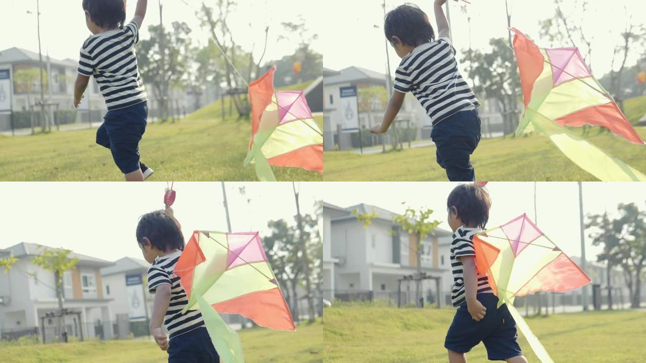 亚洲小男孩在阳光明媚的日子跑步风筝自由概念夏季自然场。