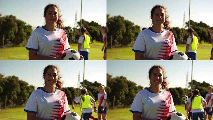 女足球运动员持球，队友在足球场上训练。4k