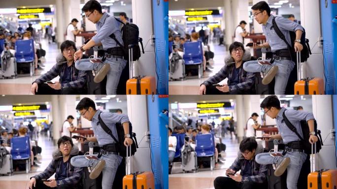 两名亚裔男子因天气原因在机场等待延误航班时感到不适