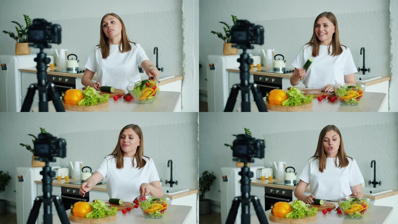 迷人的女孩视频记录器在厨房录制视频，展示蔬菜烹饪