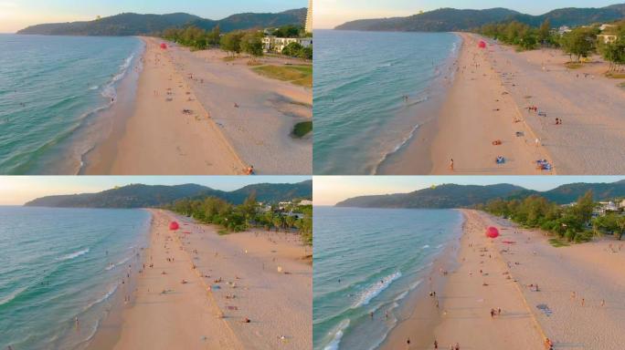 泰国普吉岛-2020年3月15日: 卡隆海滩日落，人们在海中游泳，享受日光浴，度假海滩。由于检疫新型
