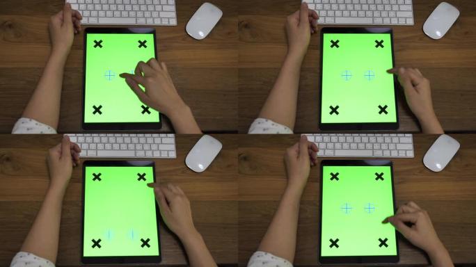 女人在办公桌上使用数字平板电脑绿屏