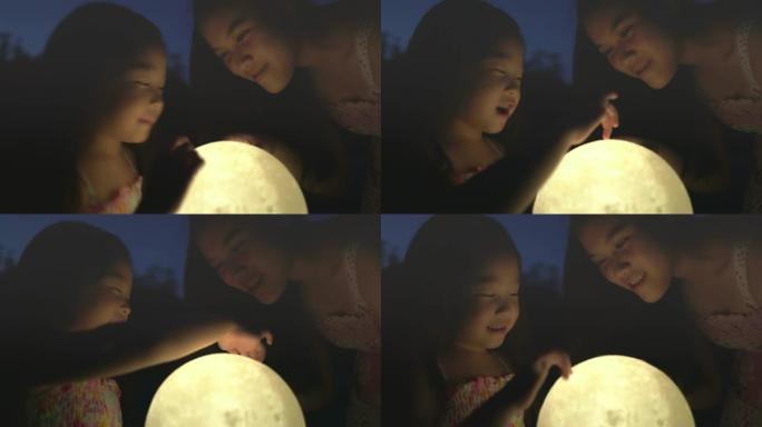 孩子们在晚上抱着月亮