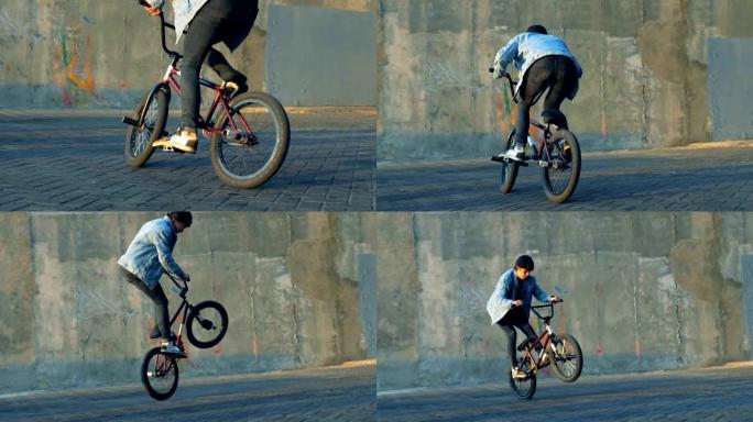 少年在BMX自行车上做戏，慢动作。