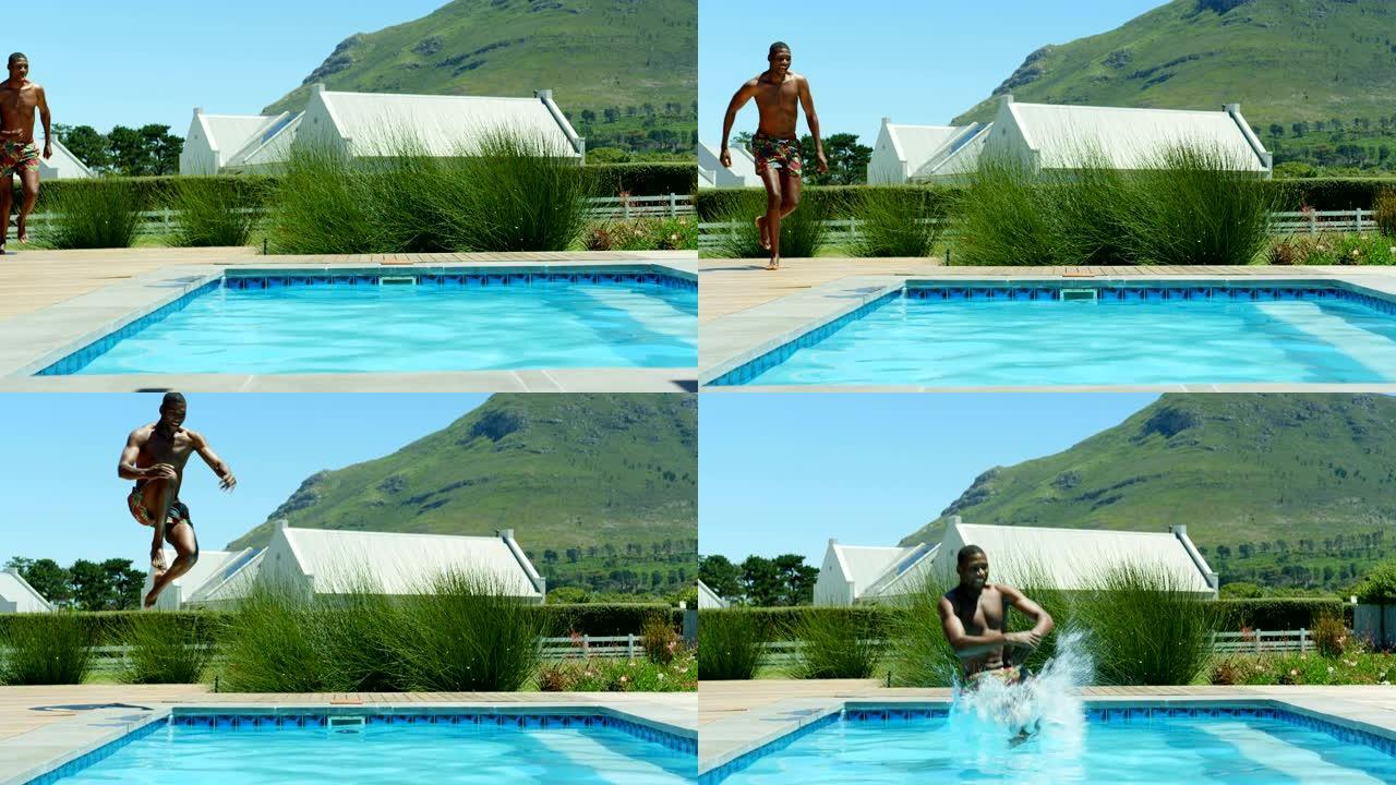 年轻的黑人男子在4k度假村的游泳池里跳
