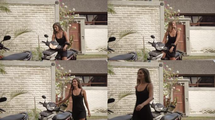 一名妇女在热带村庄的街道上停下摩托车