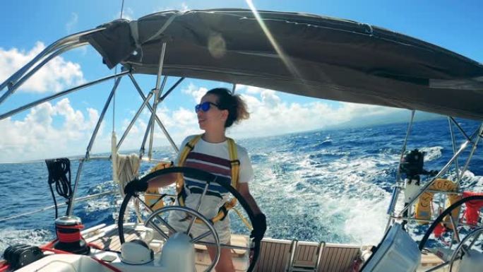 一个女人在乘船时跳舞的前视图。享受游艇度假的年轻女船长。