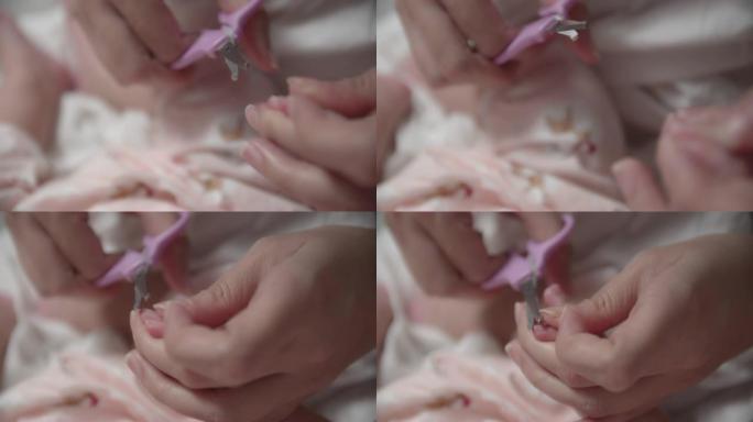 母亲在刚出生的婴儿上剪指甲