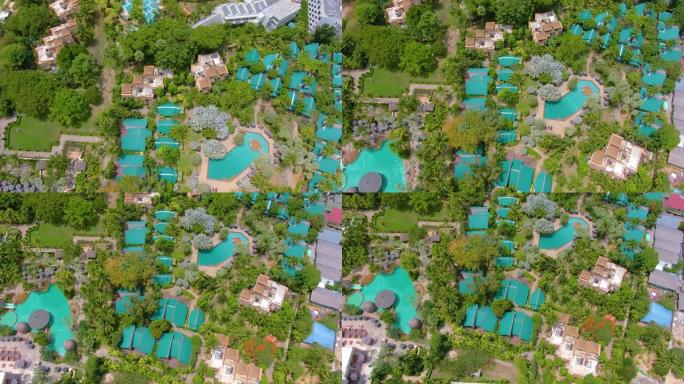 豪华酒店度假村自上而下的无人机空中4k视图。棕榈树、遮阳伞、热水浴缸。滑水。游泳池、花园和海滩从上面