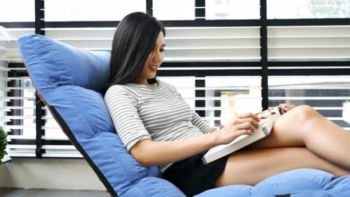 亚洲女人在家看书躺椅休闲时光美女看书