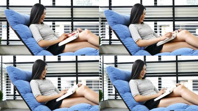 亚洲女人在家看书躺椅休闲时光美女看书