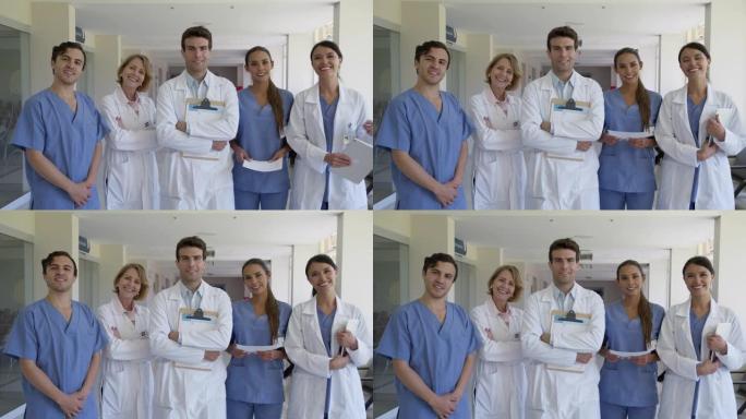 医院医疗保健专业人员的混合年龄范围团队对着镜头微笑