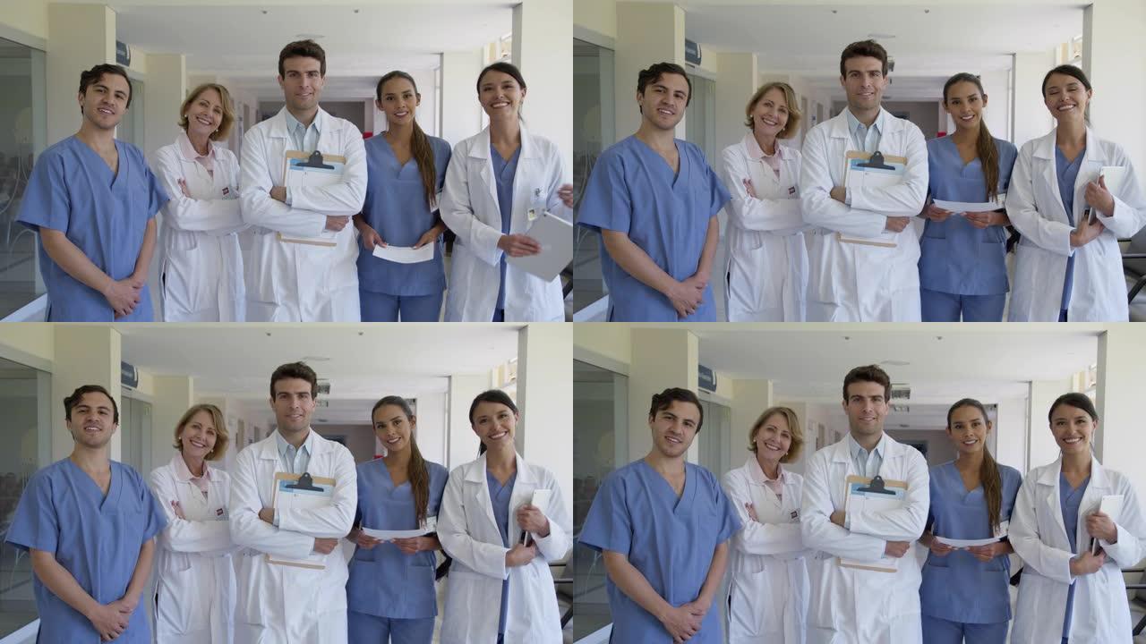 医院医疗保健专业人员的混合年龄范围团队对着镜头微笑