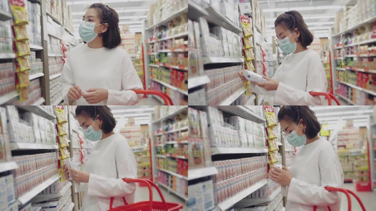 戴着防护口罩的年轻女孩在超市购物。