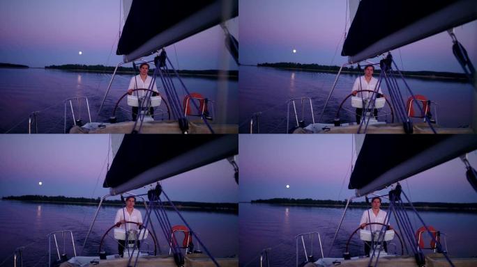 湖上浪漫的日落。享受帆船运动的年轻人