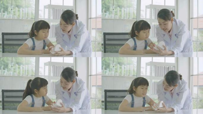 小亚洲学生女孩在解剖学课上学习下颌模型的人体骨骼。科学与教育。