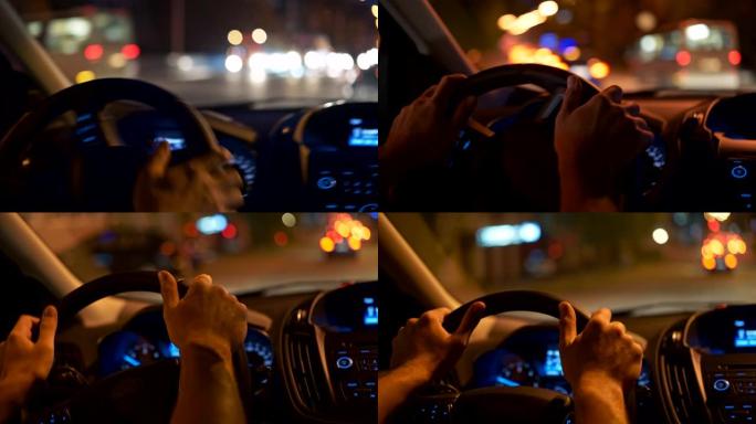 男子在左转时手握方向盘，在夜城开车。充满彩灯的城市。UHD