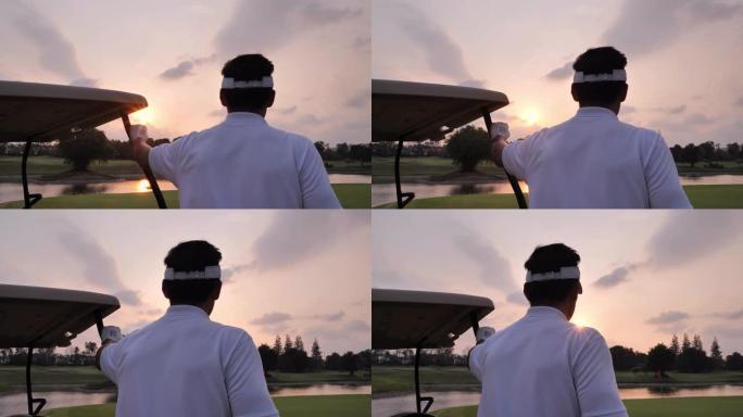 视觉概念。成功的商人站在高尔夫球场上，俯瞰日落。体育电影