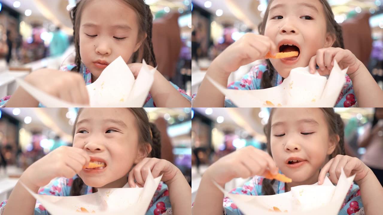 吃炸薯条的亚洲小女孩