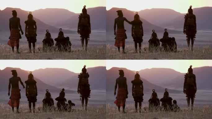 纳米比亚纳米布沙漠中，身着传统服饰的希姆巴部落的人们观看日落的4K画面