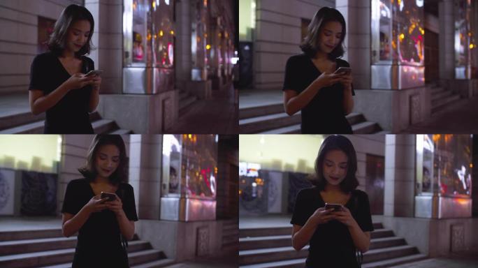 城市中使用手机的年轻亚洲女性的慢动作