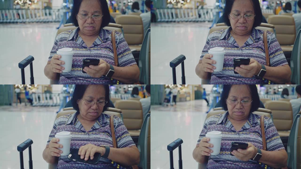 在机场使用智能手机的高级女性