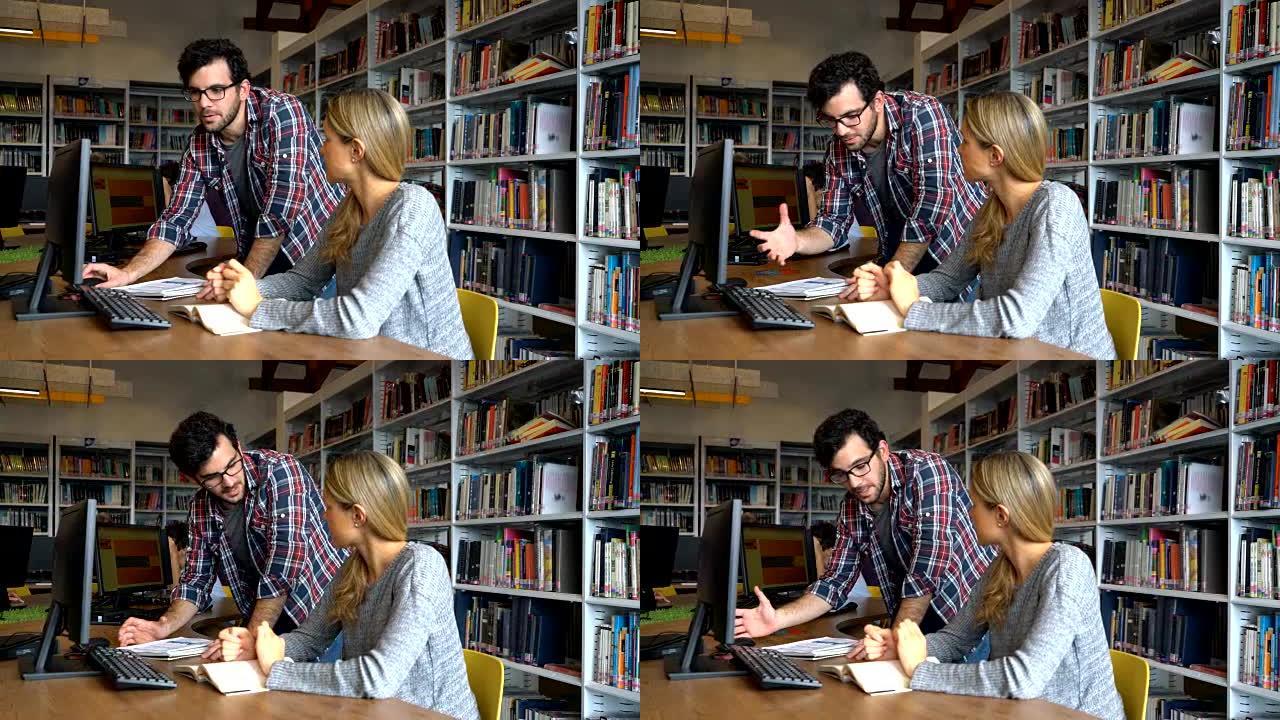 男同学一边看文件和电脑，一边在图书馆向女性解释一些事情
