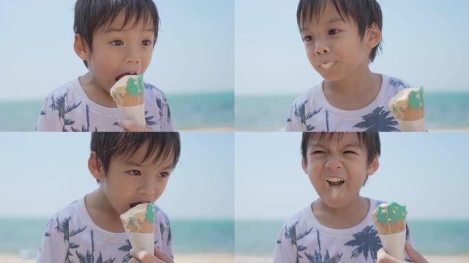 快乐的小男孩在海边的海滩上吃冰淇淋