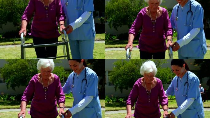 高加索女医生的前视图，帮助高级患者在nu花园中与walker一起行走