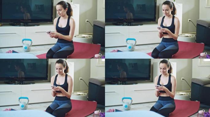 SLO MO年轻女子在锻炼时使用智能手机