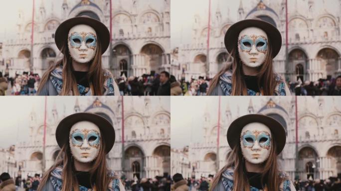 长头发女人的特写镜头全脸传统狂欢节面具站在威尼斯城市广场慢动作。