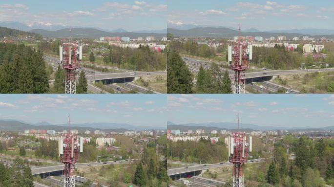 空中: 在高速公路旁的红色和白色电信塔周围飞行。