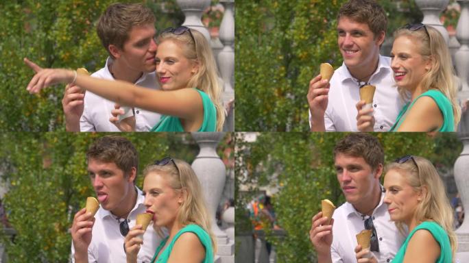 慢动作: 快乐男人一边吃冰淇淋，一边亲吻女友的额头