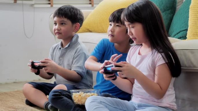 一群孩子在家玩电子游戏，快乐有趣。早期教育和学习。教育，儿童，技术，科学和人的观念。