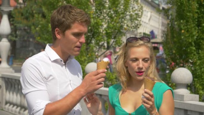 特写: 男人在吃冰淇淋和探索卢布尔雅那时亲吻女友。