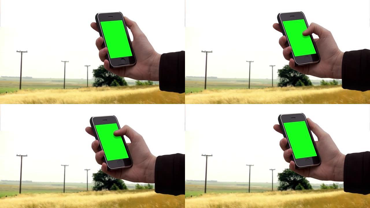 在农村地区使用旧智能手机的人。特写。