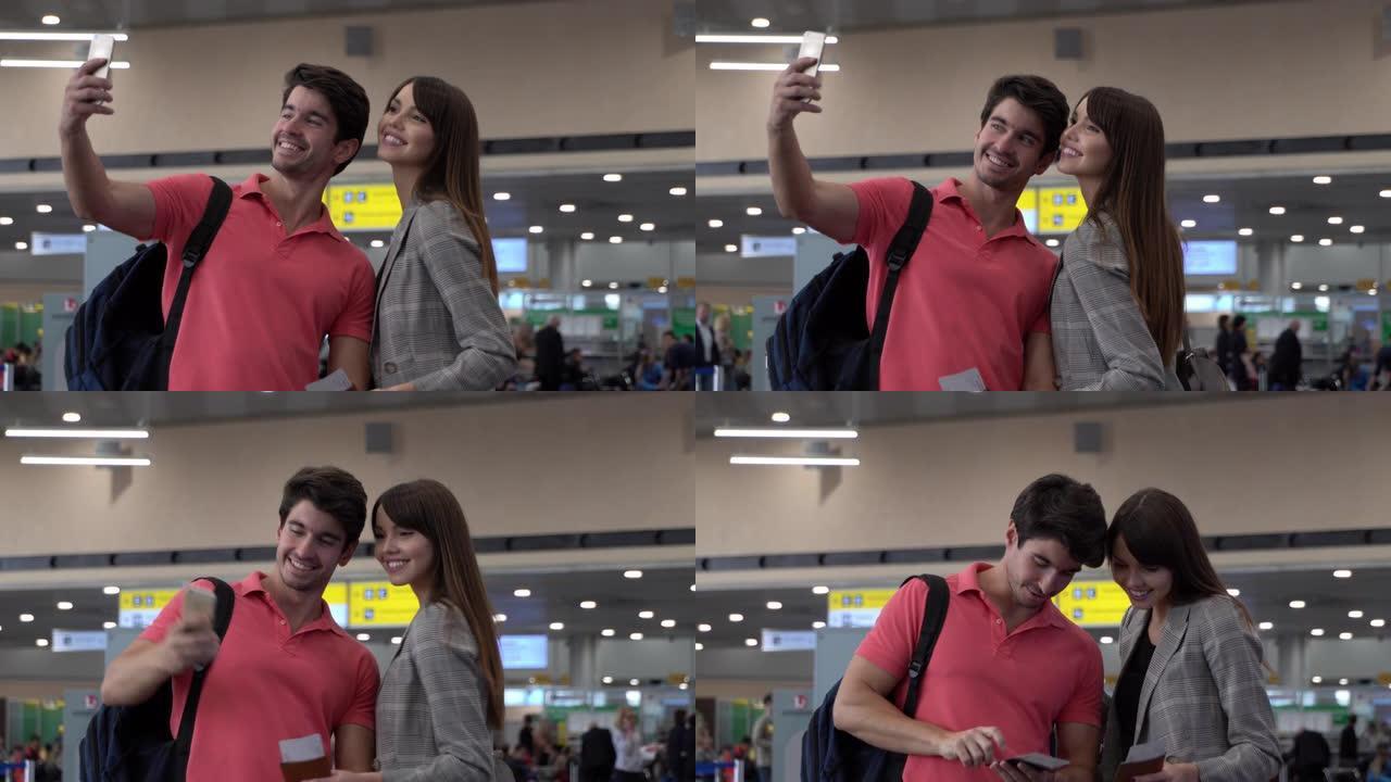 在机场的幸福夫妇用智能手机自拍，微笑着看着它
