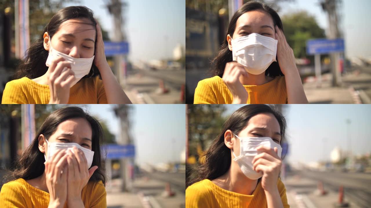 亚洲妇女咳嗽与面罩保护在街上