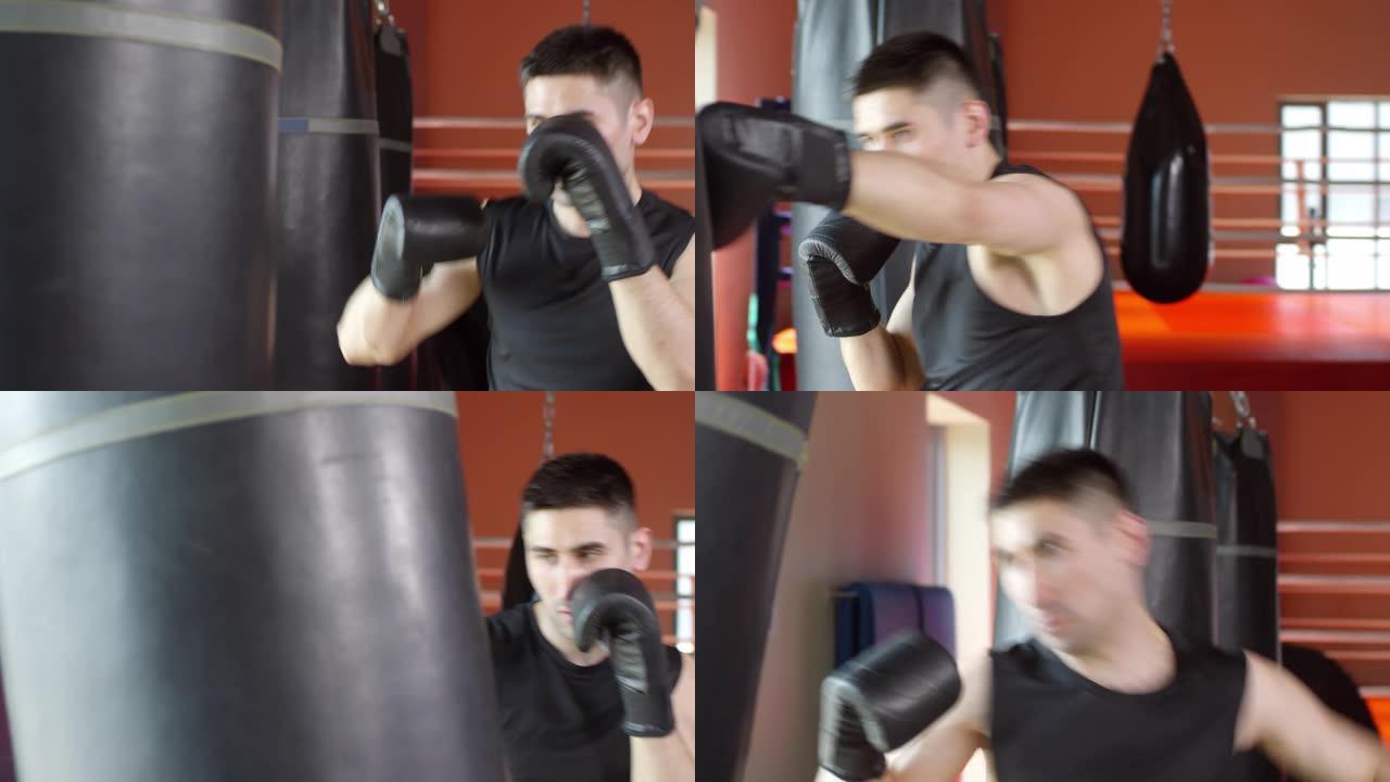 男拳击手在健身房练习拳打