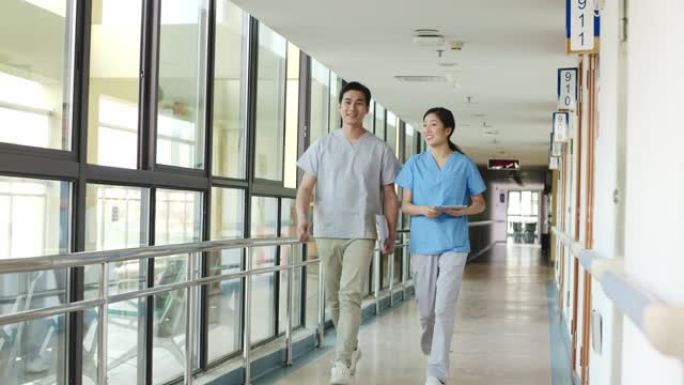 年轻的亚洲医疗保健专业人员走在医疗机构的走廊上