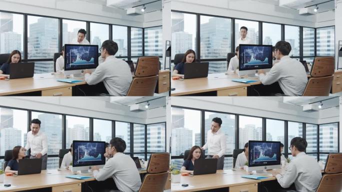 4K UHD: 亚洲经理或老板向团队教学和解释工作。